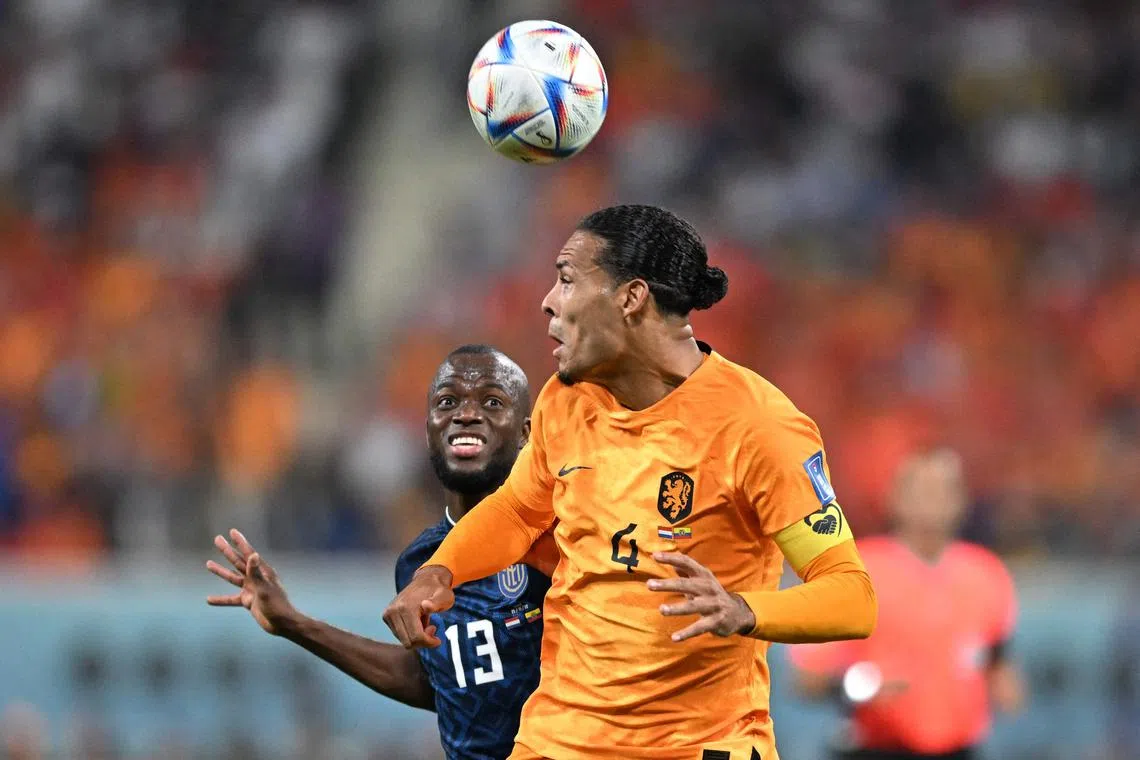 Ecuador forward Enner Valencia fights for the ball with Netherlands defender Virgil van Dijk.