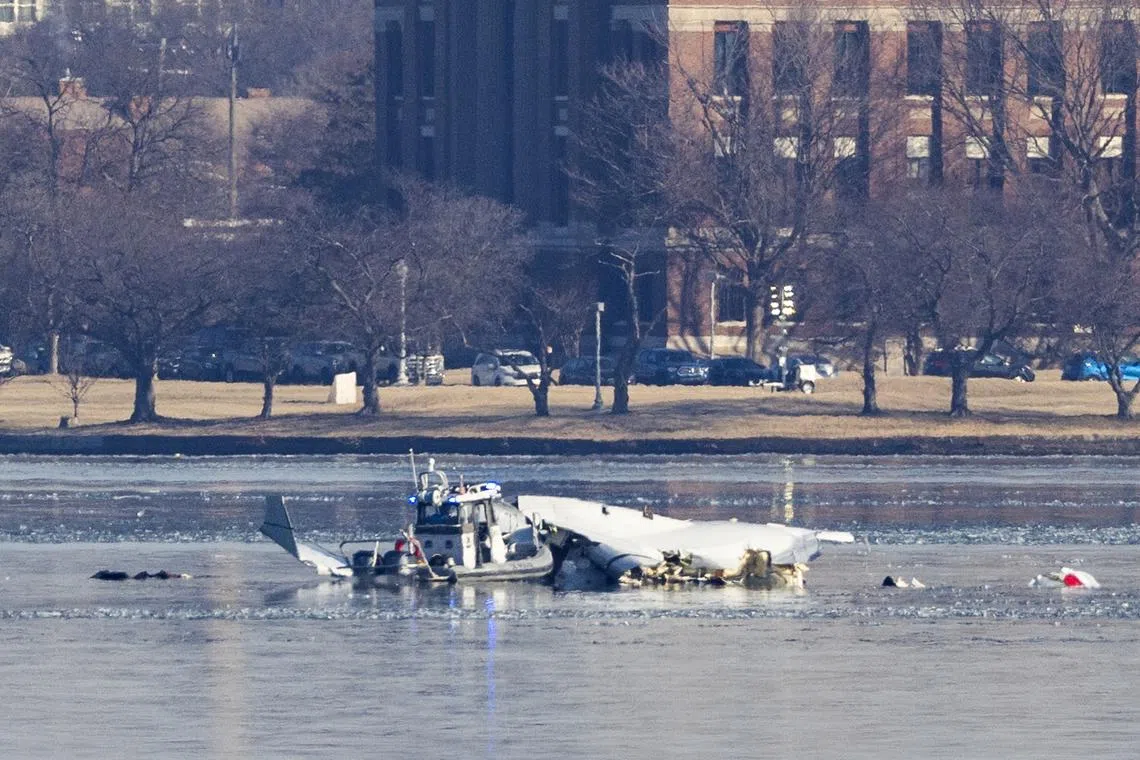 Rescue teams search the wreckage of a commercial airplane that collided with a military helicopter, in Washington, DC, on Jan 30.