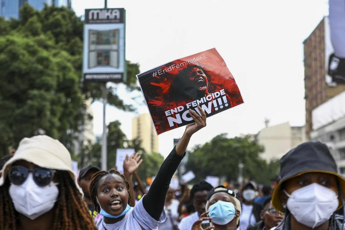 A Kenyan protester holds a placard as people participate in a nationwide protest against increasing femicide cases in the country on Jan 27.