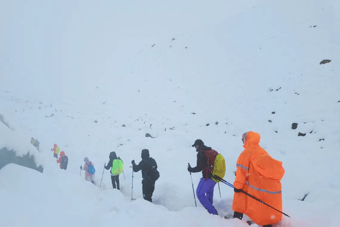 A screen capture from video shows trekkers leaving their campsite, as unusually heavy snow and rainfall pummeled the Himalayas, in the Tibet Region, China, October 5, 2025. Geshuang Chen/Handout via REUTERS