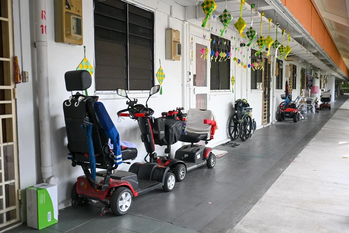 Items, such as personal mobility aids, seen along the corridor of housing units at a block in Toa Payoh North on Aug 5.