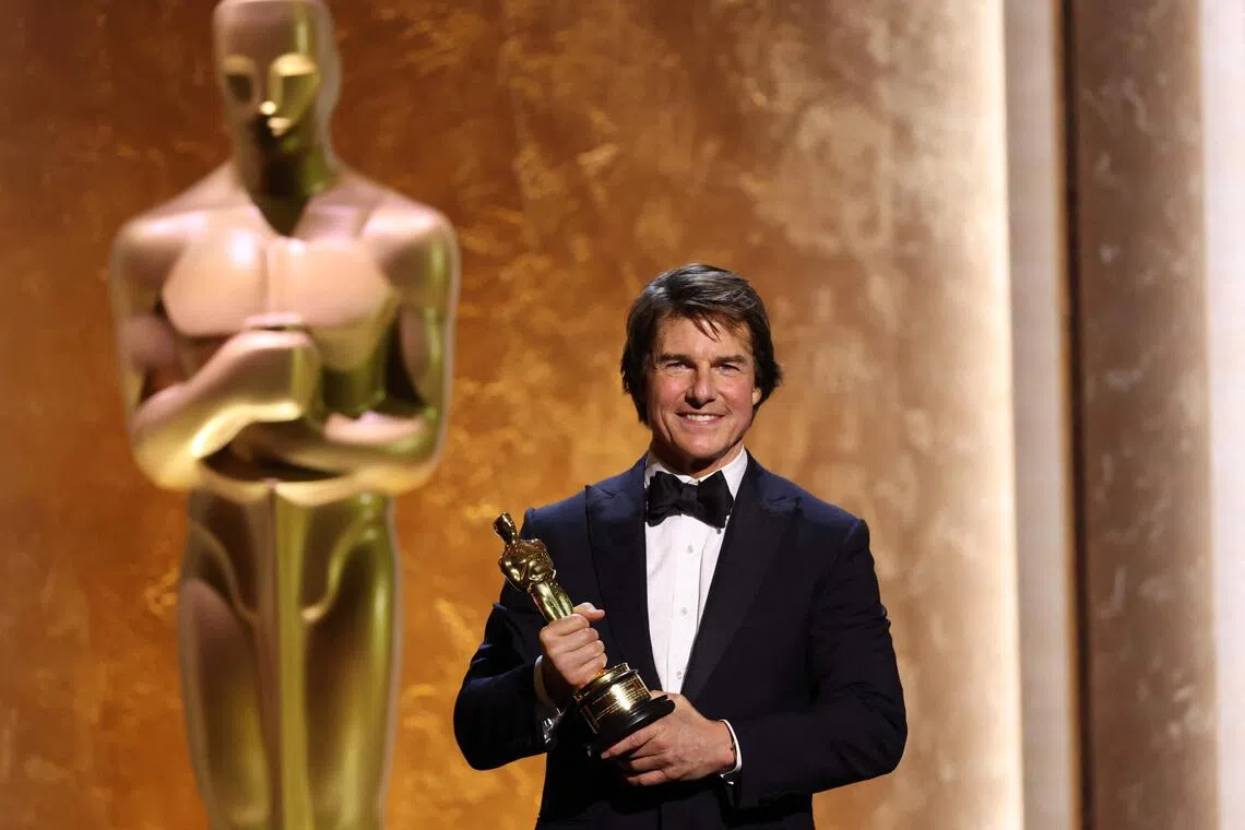 Tom Cruise poses with his Honorary Academy Award on stage during the 16th Governors Awards in Los Angeles on Nov 16.
