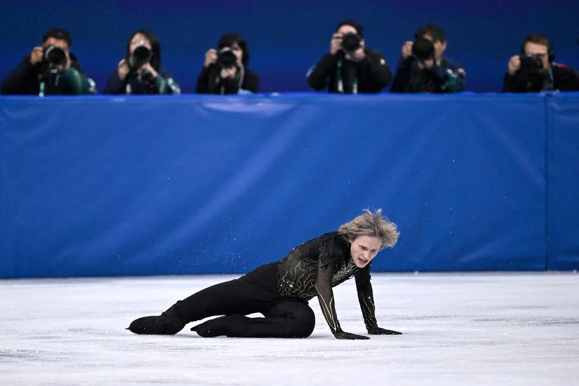 Ilia Malinin falls while competing in the men's figure skating at the Winter Olympic Games in Italy on Feb 13.
