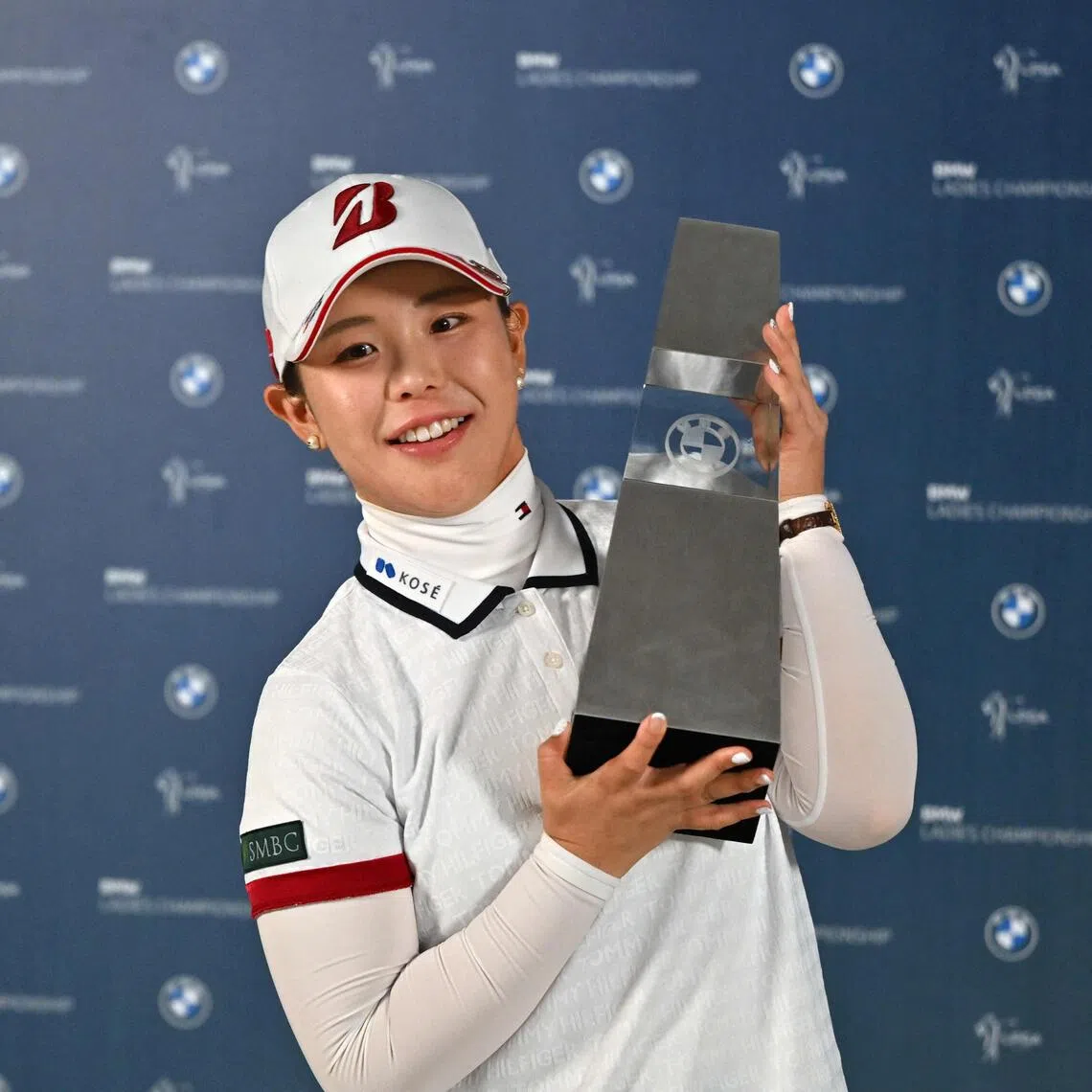 A happy Yuri Yoshida celebrating her maiden victory on the LPGA Tour with the BMW Ladies Championship trophy after winning at Pine Beach Golf Links in Haenam, South Korea on Oct 25.