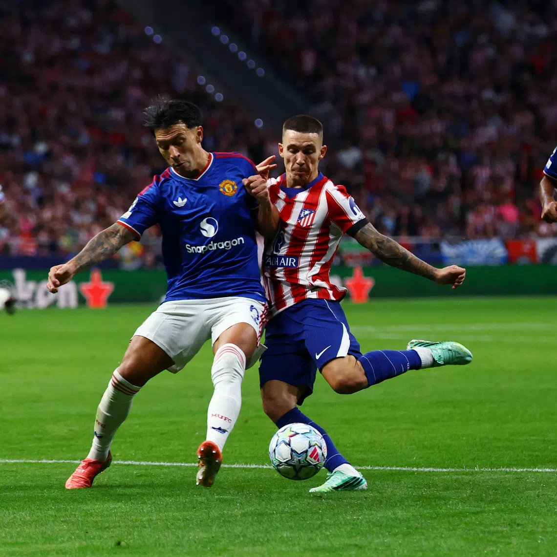 Soccer Football - UEFA Champions League - Atletico Madrid v Manchester United - Riyadh Air Metropolitano, Madrid, Spain - October 13, 2026 Manchester United's Lisandro Martinez in action with Atletico Madrid's Alejandro Grimaldo REUTERS/Susana Vera