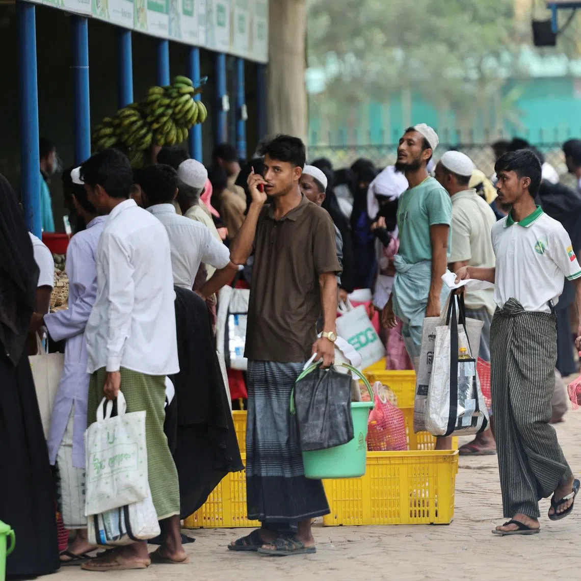 Rohingya refugees stand in queue to receive ration from the World Food Program(WFP), at a refugee camp in Cox's Bazar, Bangladesh, April 18, 2026.
