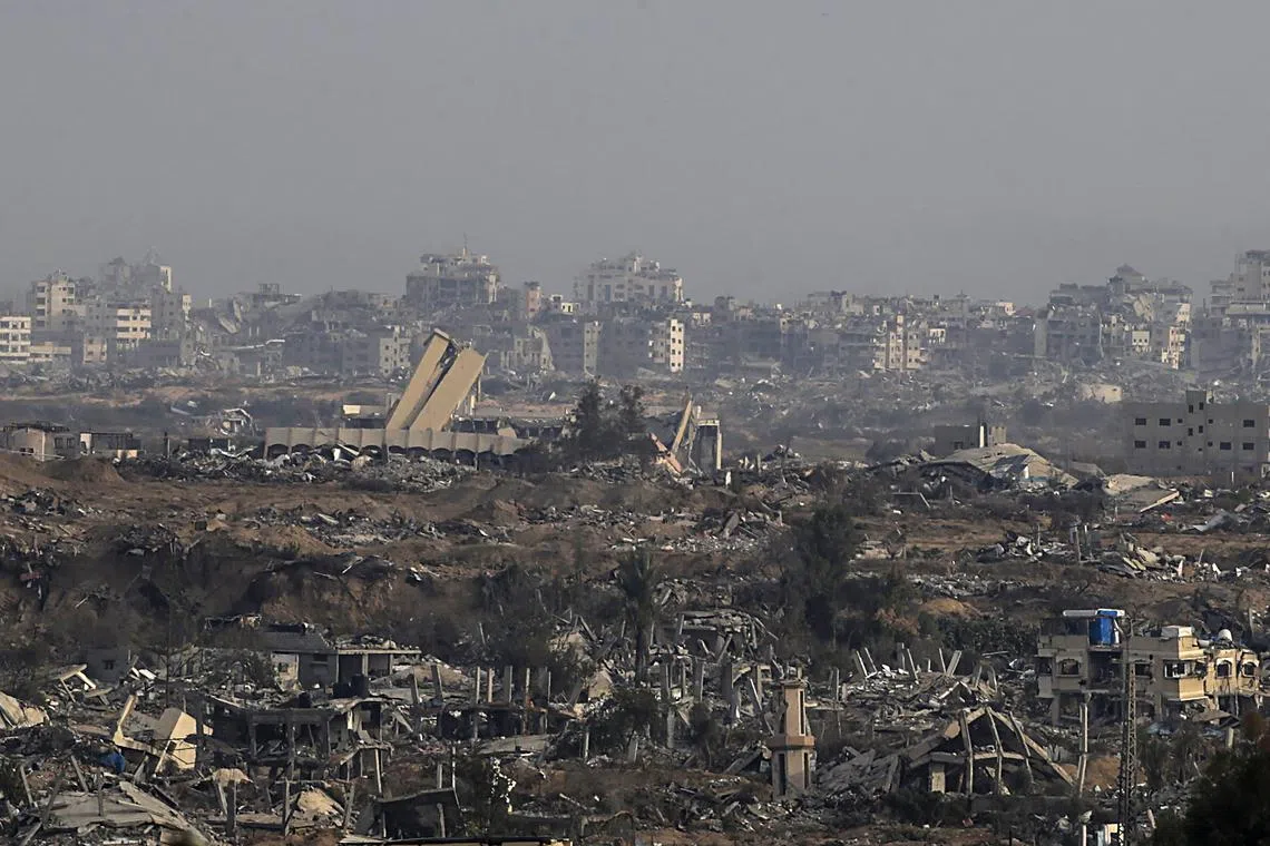 Destruction in the northern Gaza Strip (rear) as seen from Al Nuseirat refugee camp, central Gaza Strip, on Dec 7.