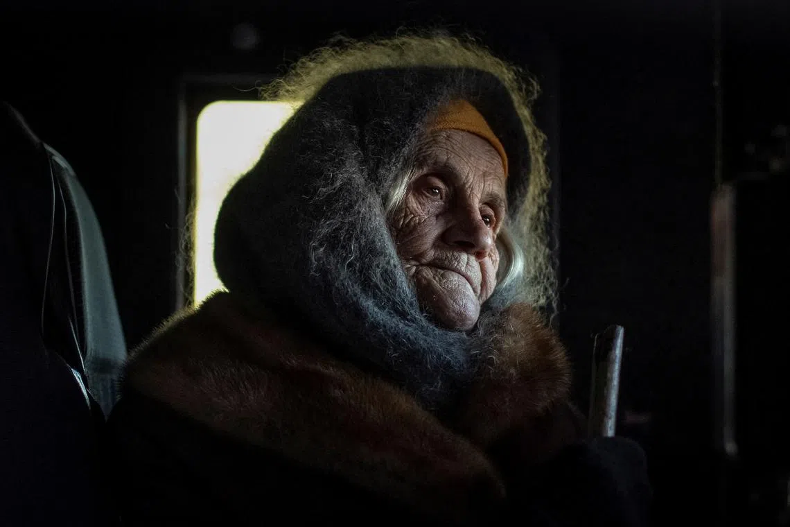 A local resident Oleksandra Koshkina, 85, sits in a car as she comebacks in her village of Torske near a frontline, amid Russia's attack on Ukraine, Donetsk region, Ukraine December 20, 2022.  