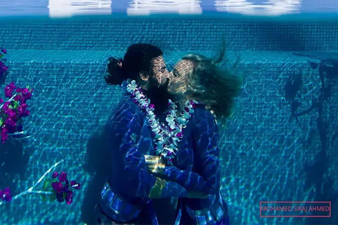 fdkiss14 - The couple broke the Guinness World Record for the longest underwater kiss.

Credit:  Mohamed Siraj Ahmed