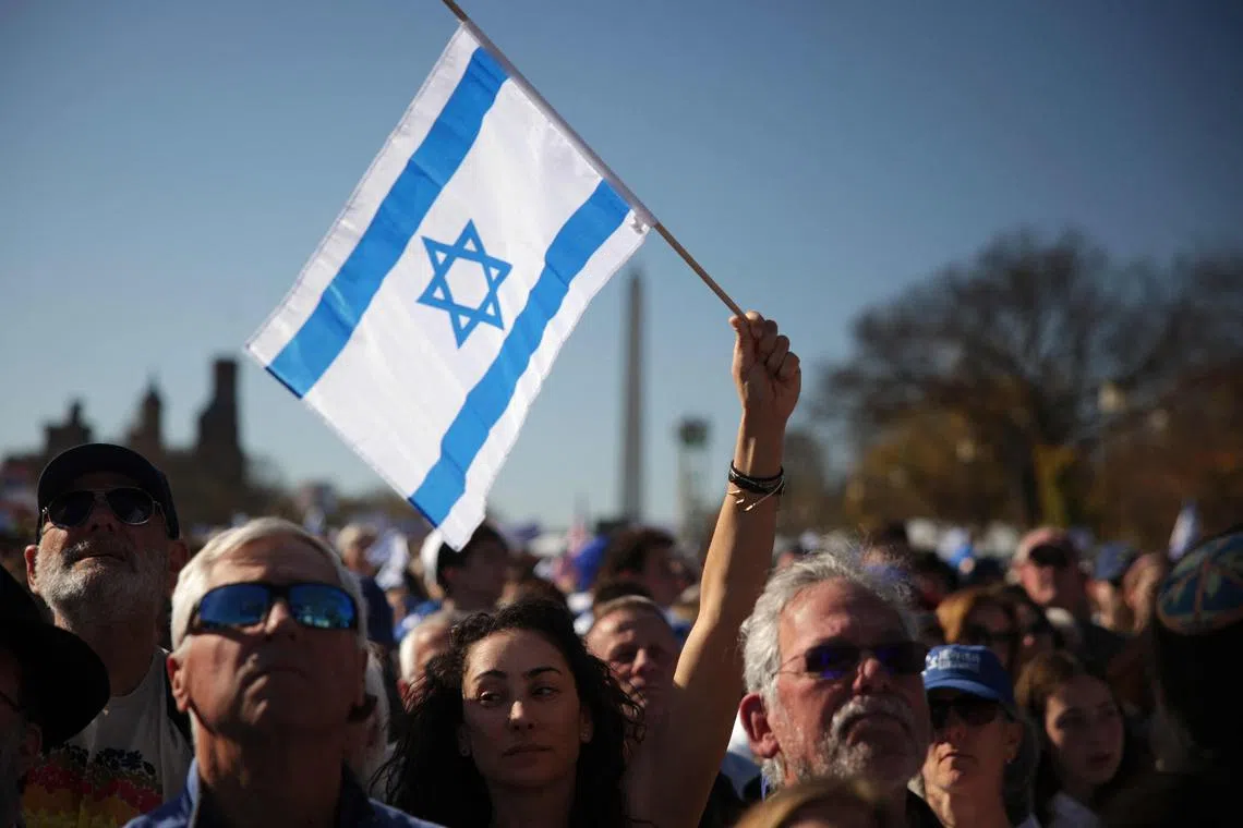 Thousands of people gathered in bright sunshine on the National Mall, many draped in Israeli and US flags.