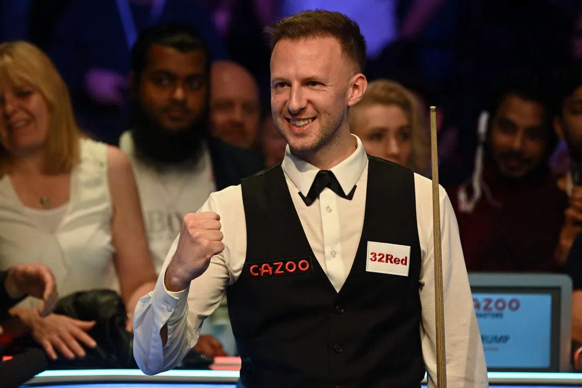 England's Judd Trump celebrates after his victory over Wales' Mark Williams in the Masters snooker tournament final at Alexandra Palace in London on Sunday. 