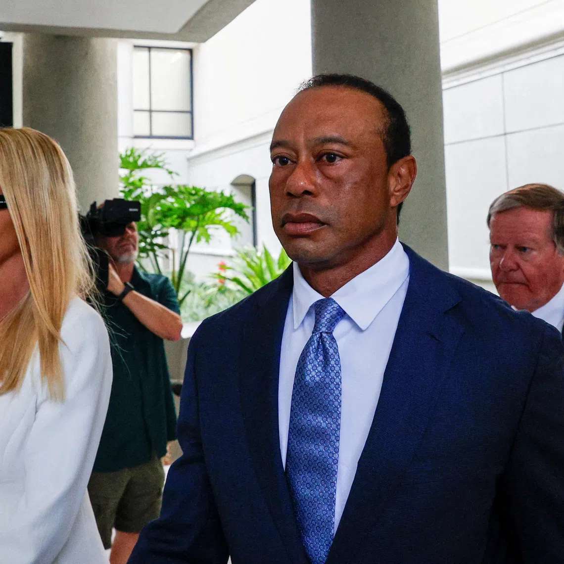 Golfer Tiger Woods flanked by his girlfriend, Vanessa Trump, leaves the courthouse after his scheduled appearance before a judge in person for the first time since his March 27 car accident, when he was arrested on a misdemeanor driving under the influence (DUI) charge after a rollover crash, in Stuart, Florida, U.S., September 2, 2026. REUTERS/Marco Bello
