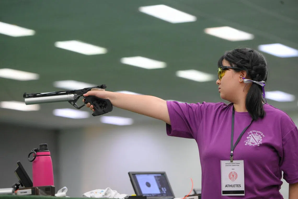 Eunice Khoo of CHIJ St. Joseph's Convent takes a shot during the 10m air pistol girls' event at the NSG C Division Shooting Championships held at Safra Yishun on July 12.