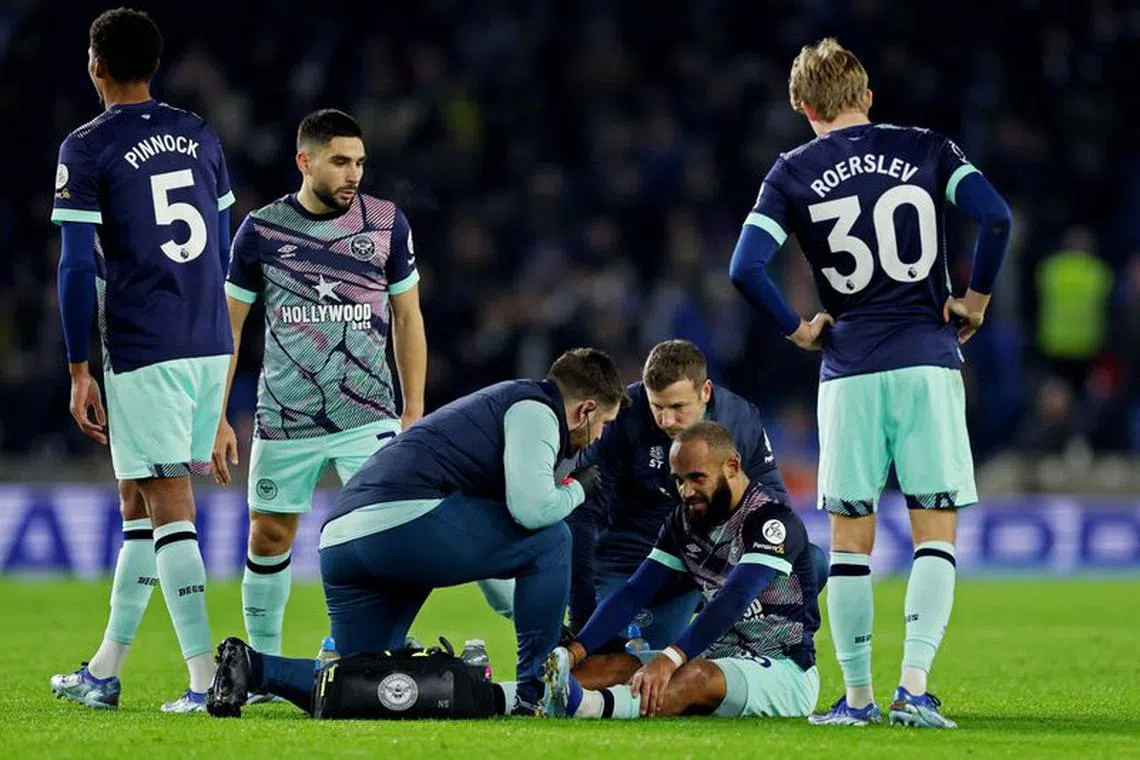Soccer Football - Premier League - Brighton & Hove Albion v Brentford - The American Express Community Stadium, Brighton, Britain - December 6, 2023 Brentford's Bryan Mbeumo receives medical attention after sustaining an injury REUTERS/Ian Walton/File Photo