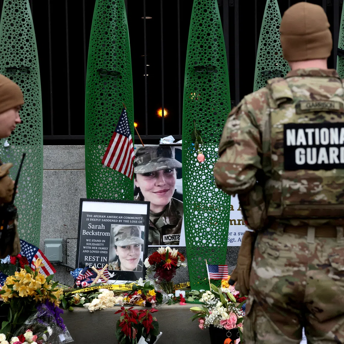 FILE PHOTO: National Guard soldiers from Alabama look at a makeshift memorial honouring West Virginia National Guard soldier Sarah Beckstrom, who, with her wounded fellow soldier Andrew Wolfe, was shot outside a subway station near the White House in Washington, D.C., U.S., December 2, 2025. REUTERS/Evelyn Hockstein/File Photo
