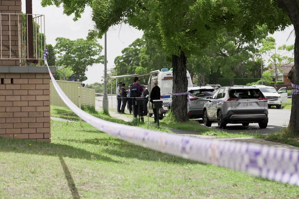 Police officers stand guard outside the house of the suspects of a shooting incident on a Jewish holiday celebration at Bondi Beach, in Bonnyrigg, Sydney, Australia, December 15, 2025. REUTERS/Alasdair Pal
