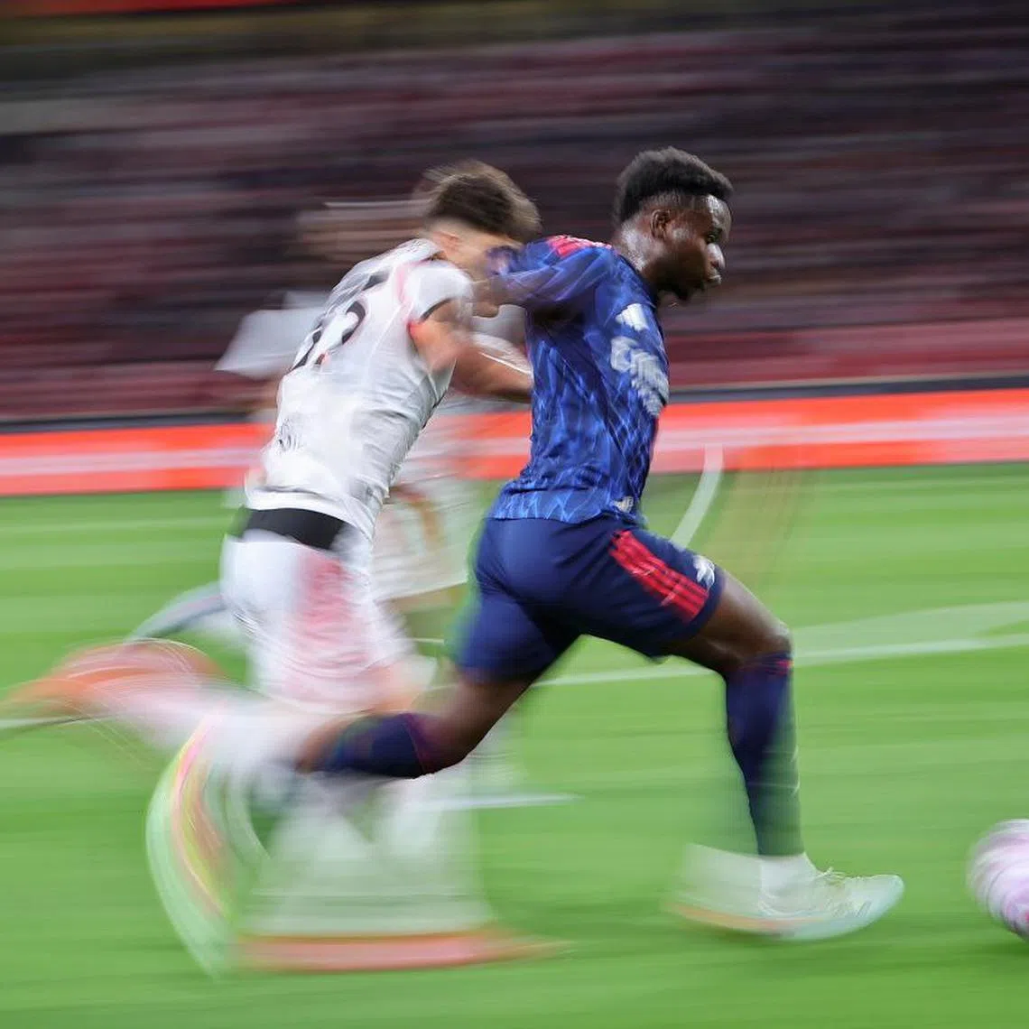 Arsenal's Bukayo Saka (in blue) scored the only goal in his side's win over Italian side AC Milan at the National Stadium on July 23.