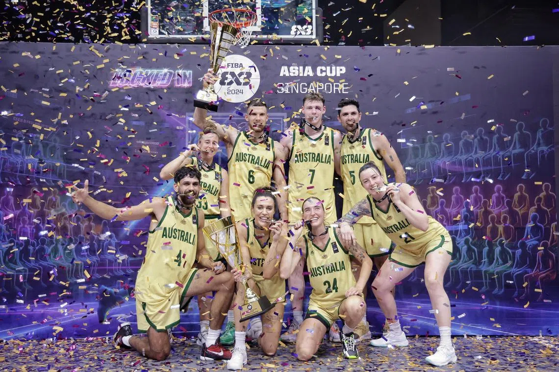 The Australian men’s and women’s team members posing with their trophies after emerging victorious from the respective finals in the FIBA 3x3 Asia Cup 2024 at OCBC Square on March 31, 2024. ST PHOTO: KEVIN LIM eabas31