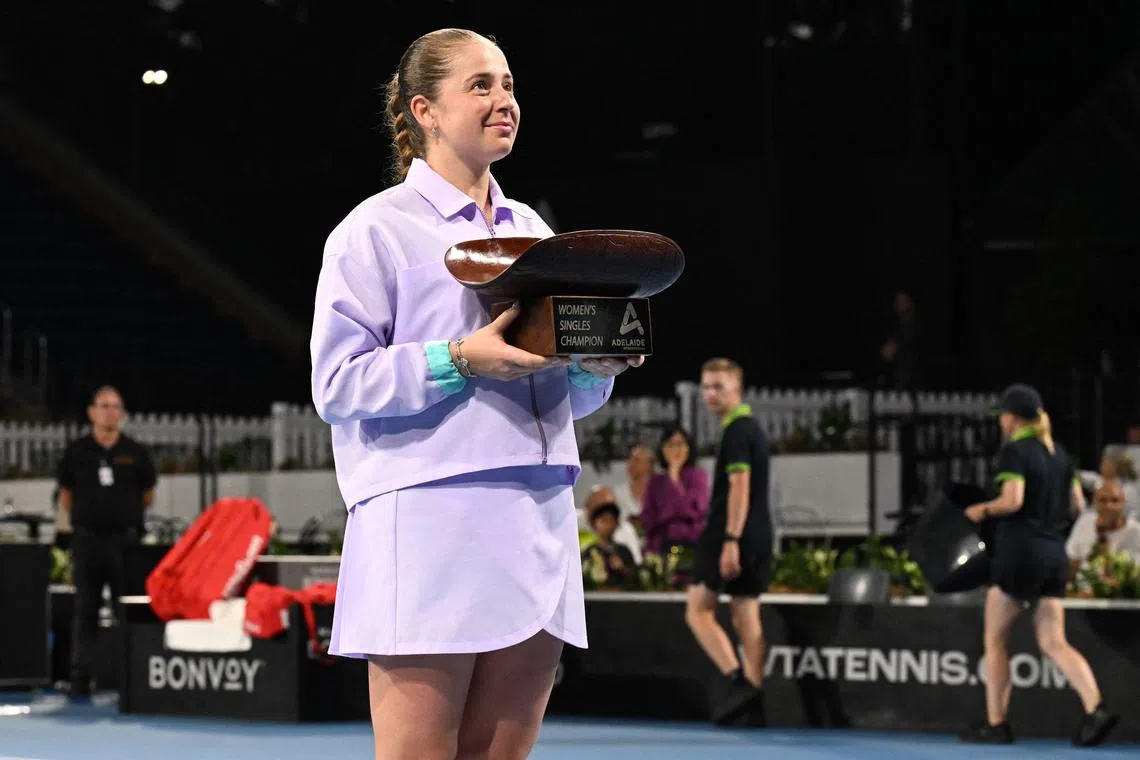 Latvia's Jelena Ostapenko poses with the trophy after defeating Russia's Daria Kasatkina in the Adelaide International final.