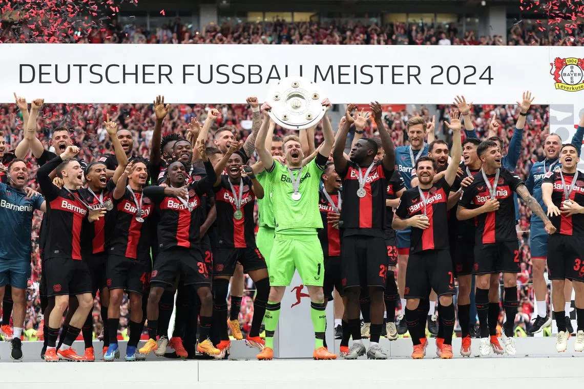FILE PHOTO: Soccer Football - Bundesliga - Bayer Leverkusen v FC Augsburg - BayArena, Leverkusen, Germany - May 18, 2024 Bayer Leverkusen's Lukas Hradecky celebrates with the trophy and team mates after winning the Bundesliga and going unbeaten REUTERS/Thilo Schmuelgen