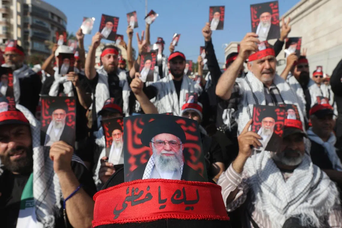 Hezbollah supporters carry photos of Iran’s Ayatollah Ali Khamenei, who has not been seen publicly in nearly a week.