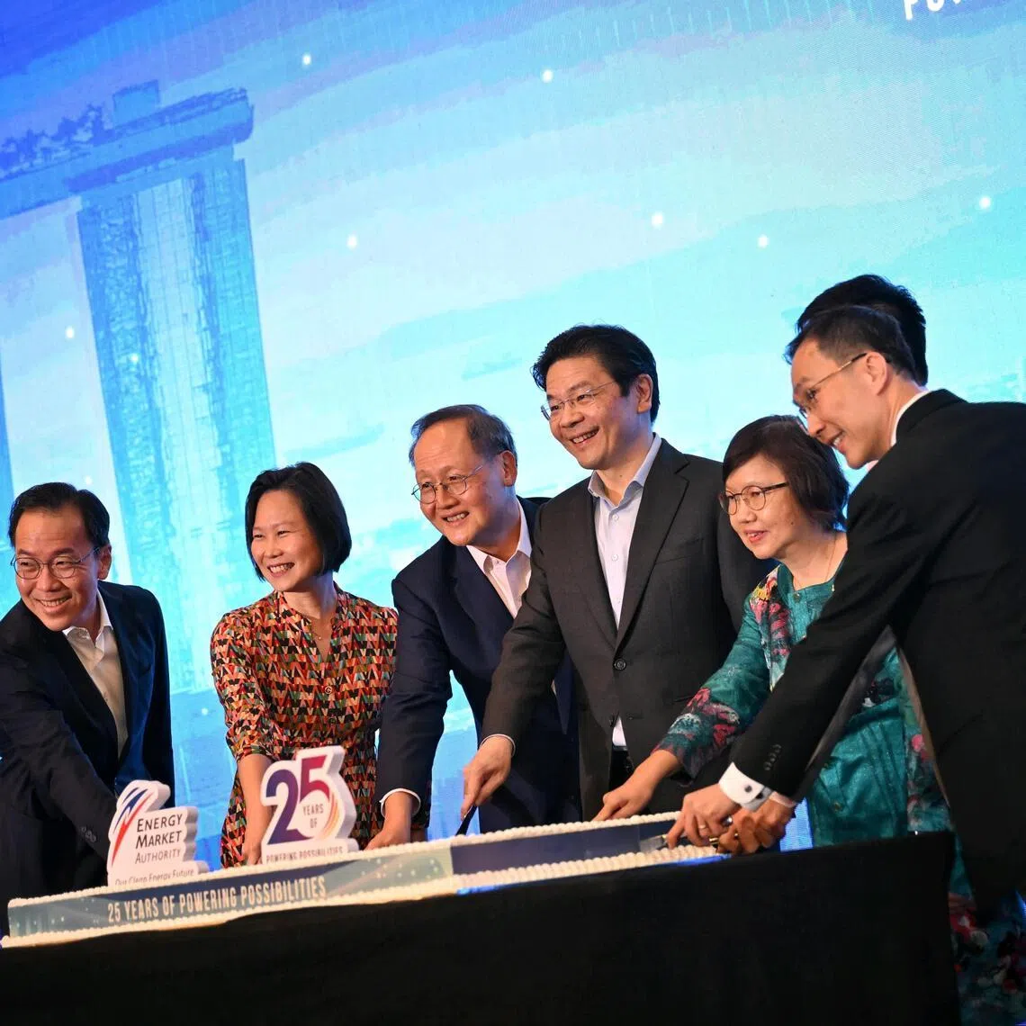 Prime Minister Lawrence Wong with (from left) Ministry of Trade and Industry permanent secretary Beh Swan Gin, Minister of State for Trade and Industry Gan Siow Huang, Manpower Minister Tan See Leng, Energy Market Authority chairman Tan Ching Yee, EMA chief executive Puah Kok Keong (partially hidden) and MTI permanent secretary for energy and trade Augustin Lee at EMA’s 25th anniversary gala dinner at Shangri-La Singapore on May 19.
