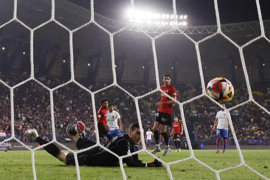 Soccer Football - Spanish Super Cup - Semi Final - FC Barcelona v Osasuna - Al-Awwal Park, Riyadh, Saudi Arabia - January 11, 2024 FC Barcelona's Lamine Yamal scores their second goal past Osasuna's Sergio Herrera REUTERS/Juan Medina