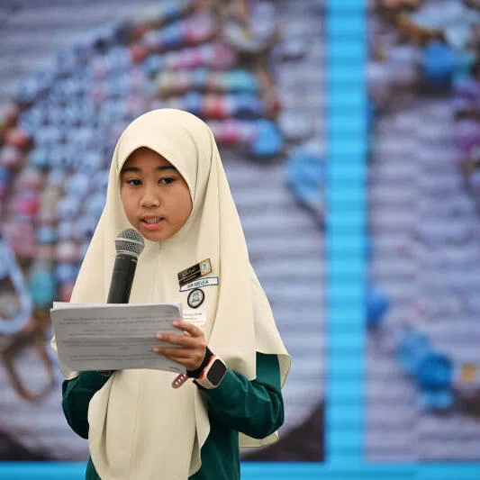 Nor Adeleia Noorhakim from Madrasah Irsyad Zuhri Islamiah sharing on stage at the Straits Times School Pocket Money Fund annual appreciation lunch.