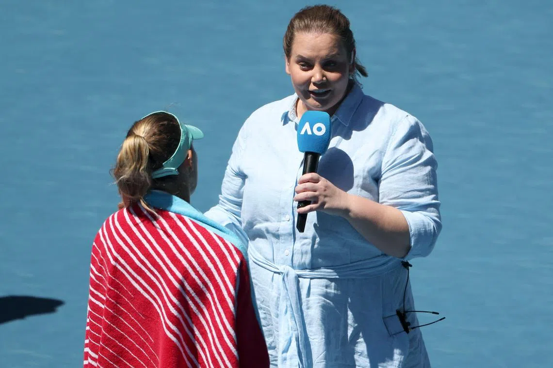 Player-turned commentator Jelena Dokic (R) talks to Poland's Magda Linette after her women's singles match against France's Caroline Garcia at the Australian Open on Monday.