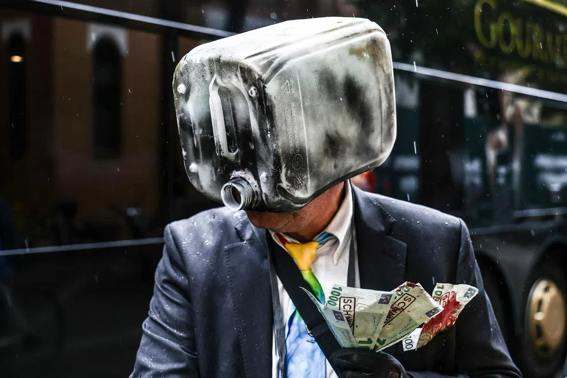 A protester wearing an oil canister mask taking part in a demonstration outside the InterContinental Hotel in Berlin, Germany, 11 June 2026.