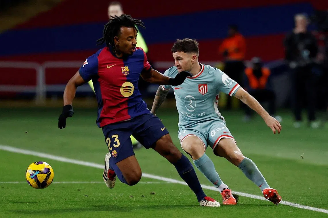 FILE PHOTO: Soccer Football - LaLiga - FC Barcelona v Atletico Madrid - Estadi Olimpic Lluis Companys, Barcelona, Spain - December 21, 2024 Atletico Madrid's Javi Galan in action with FC Barcelona's Jules Kounde REUTERS/Juan Medina/File Photo