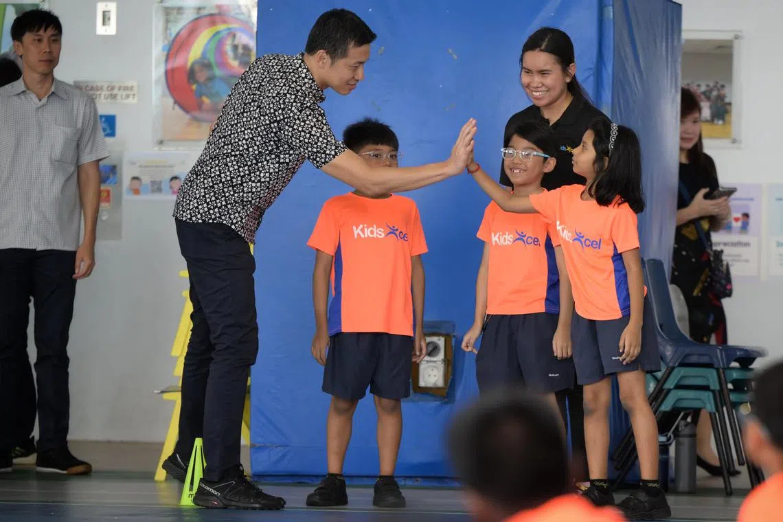 Acting MCCY Minister David Neo interacting with students from the KidExcel+ programme run by the charity, Catch Them Young.