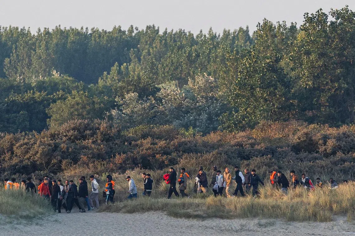 Migrants waiting for a smuggler's boat on the beach of Gravelines, in northern France, to attempt crossing the English Channel on Aug 11.