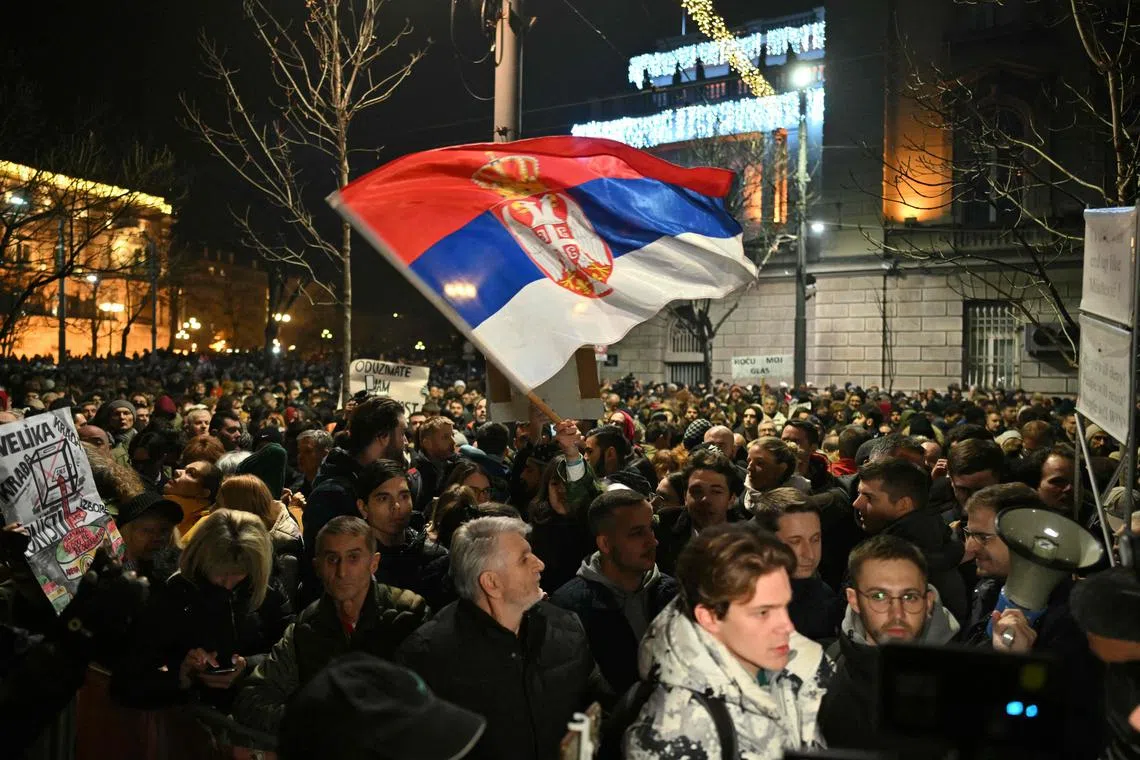 Opposition supporters protest outside the Electoral Committee building in Belgrade, one day after the results of the parliamentary and local elections were announced.