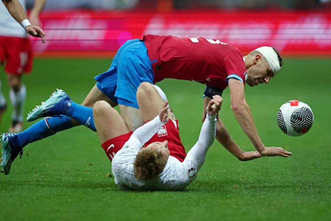 Soccer Football - UEFA Euro 2024 Qualifier - Group E - Poland v Czech Republic - PGE Narodowy, Warsaw, Poland - November 17, 2023 Czech Republic's Tomas Soucek in action with Poland's Adam Buksa REUTERS/Kacper Pempel