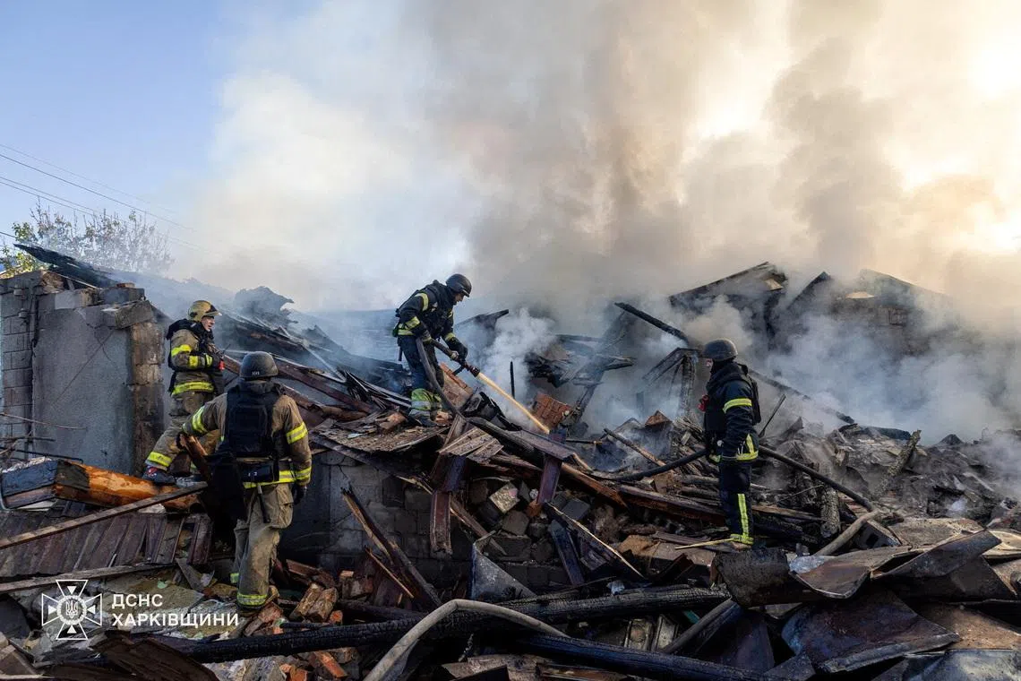 Firefighters working at the site of a private household hit during morning Russian drone strikes, amid Russia's attack on Ukraine, Kharkiv, Ukraine on May 19, 2026. 
