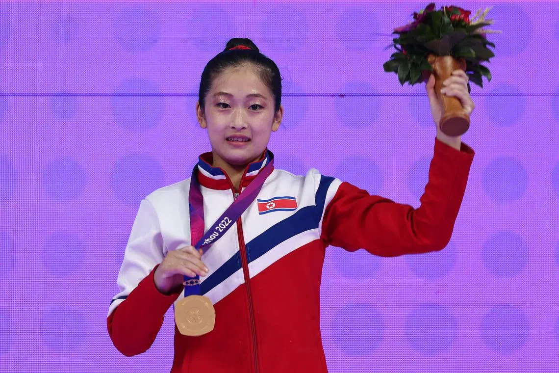 North Korea's An Chang Ok poses with her gold medal on Sept 28, 2023.