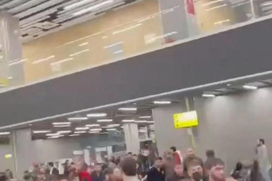 People walk as Pro-Palestinian protesters storm an airport building, in Makhachkala, Russia, October 29, 2023, in this screengrab taken from a video obtained by Reuters. Video Obtained by Reuters/via REUTERS