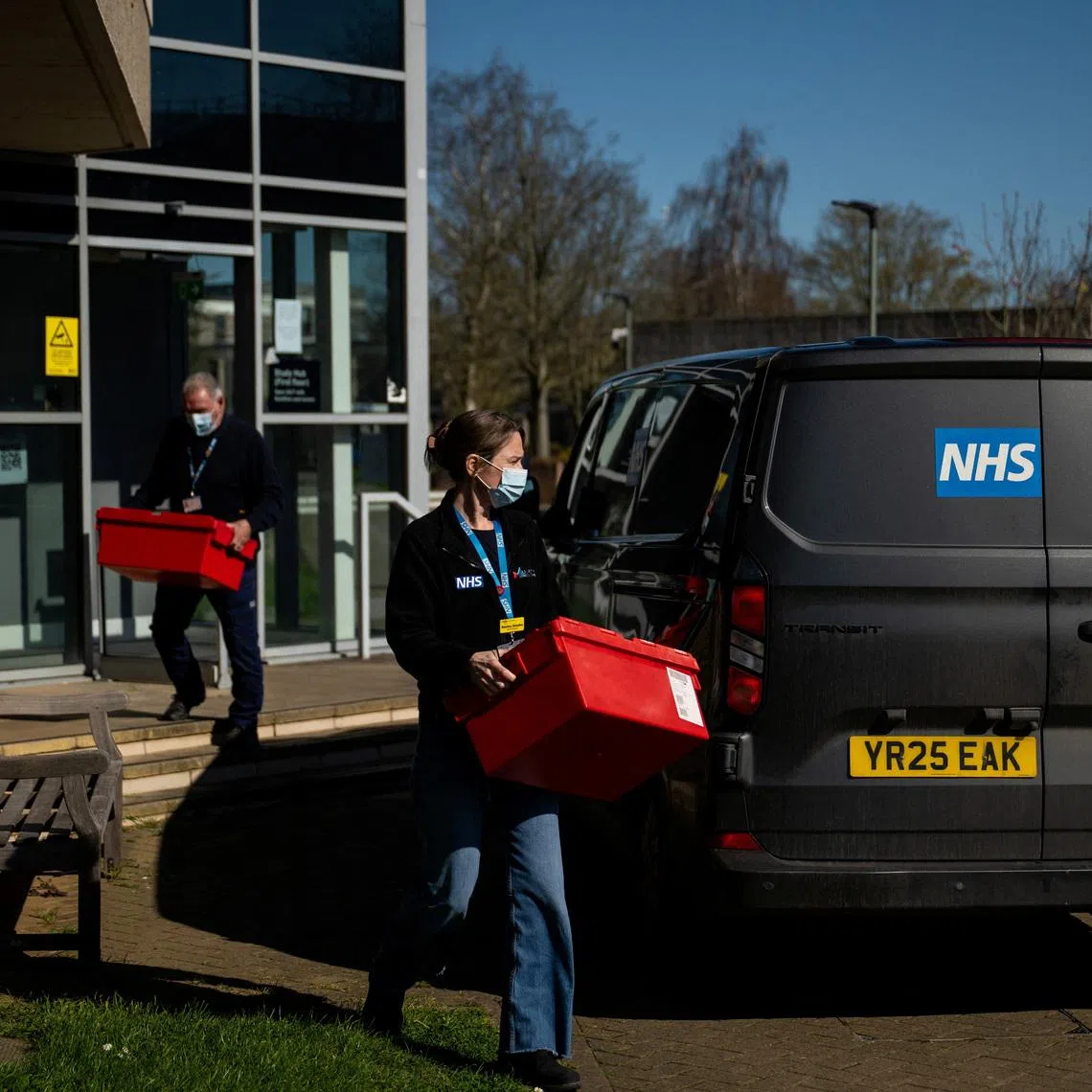 National Health Service (NHS) workers carry boxes from a building that is supplying antibiotics on the University of Kent campus following an outbreak of meningitis cases in Kent, in Canterbury, Britain, March 18, 2026. REUTERS/Chris J. Ratcliffe
