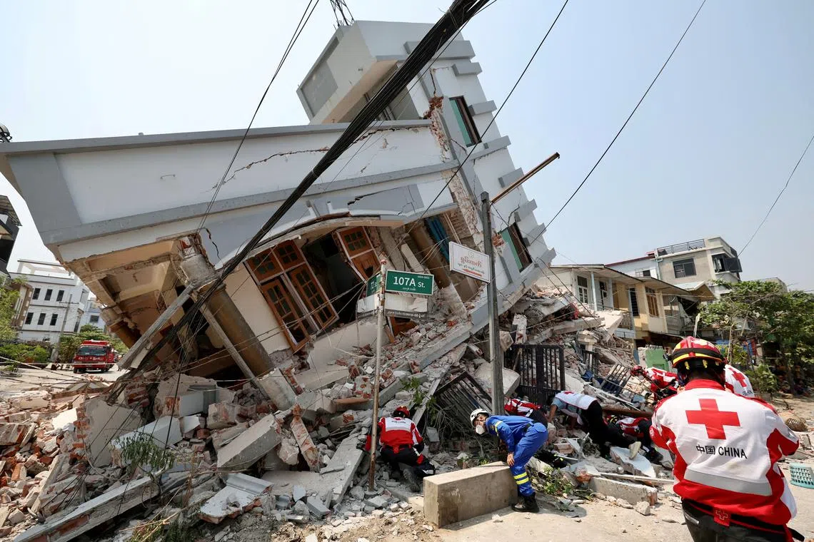 FILE PHOTO: Members of the Chinese Red Cross International Emergency Response Team work at a collapsed residential building following the earthquake, in Mandalay, Myanmar March 31, 2025. China Daily via REUTERS/File Photo