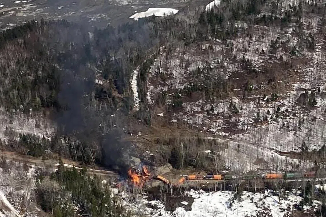 Three locomotive engines and six rail cars carrying lumber and electrical wiring derailed into a wooded area, where they caught fire.
