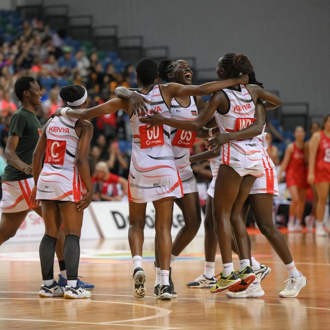 Kenya (in white) celebrate) after beating Singapore 55-42 in the final to defend their Nations Cup crown.
