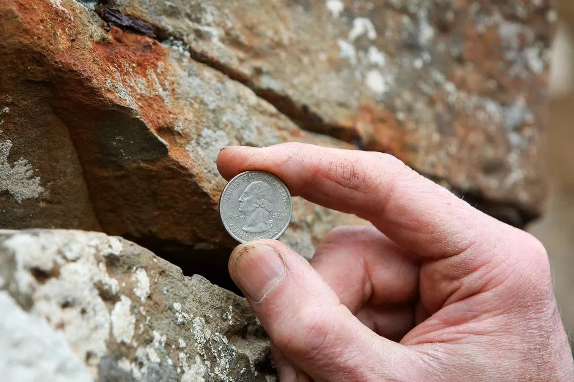 In recent decades, visitors have pushed thousands of coins into fissures in the rocks.