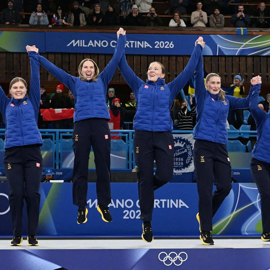 Milano Cortina 2026 Olympics - Curling - Women's Victory Ceremony - Cortina Curling Olympic Stadium, Cortina d'Ampezzo, Italy - February 22, 2026. Gold medallists Sofia Scharback of Sweden, Agnes Knochenhauer of Sweden, Sara McManus of Sweden, Anna Hasselborg of Sweden and Johanna Heldin of Sweden celebrate on the podium during the Women's Curling Victory Ceremony REUTERS/Jennifer Lorenzini