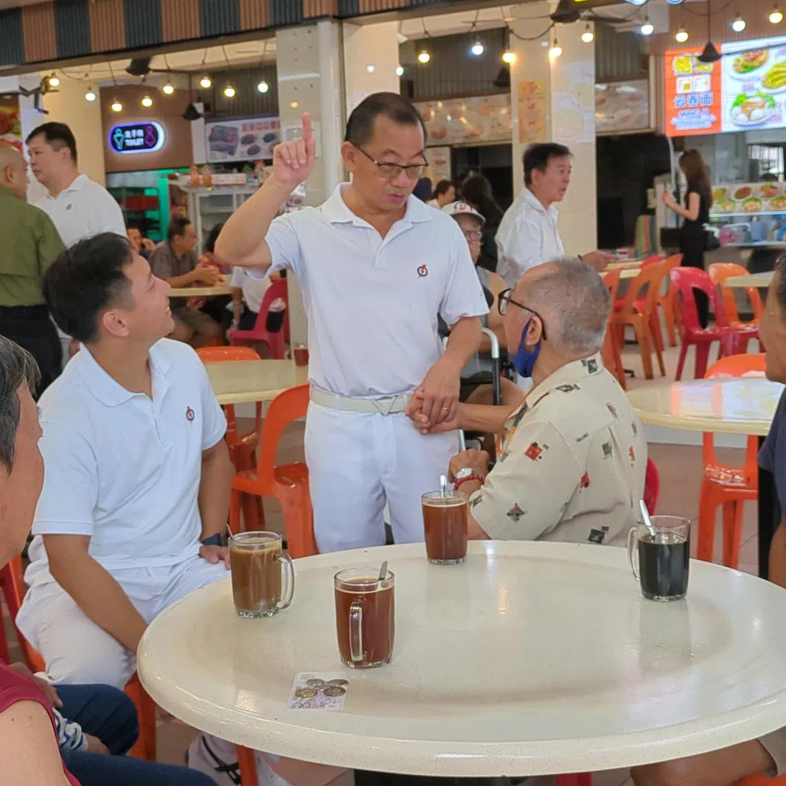 Speaker of Parliament Seah Kian Peng (centre) and Mr Goh Pei Ming (left) speaking to residents in Marine Terrace on April 24.
