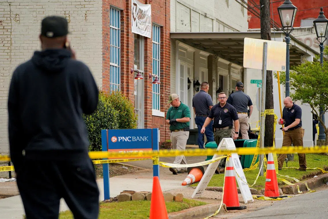 FILE PHOTO: Law enforcement officers walk through the crime scene, a day after a shooting at a teenager's birthday party in a dance studio, in Dadeville, Alabama, U.S., April 16, 2023.  REUTERS/Cheney Orr/File Photo