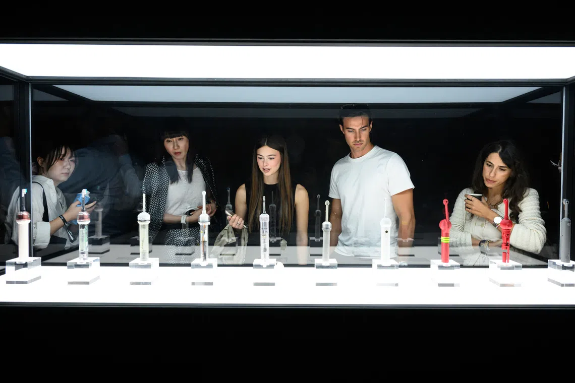 Onlookers at the launch event for the Dyson CameraJet toothbrush in Paris on Sept 1.