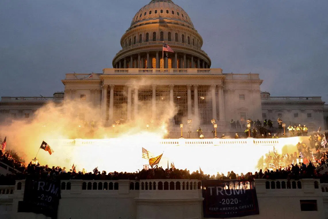 FILE PHOTO: An explosion caused by a police munition is seen while supporters of U.S. President Donald Trump riot at the U.S. Capitol Building in Washington, U.S., January 6, 2021. REUTERS/Leah Millis//File Photo