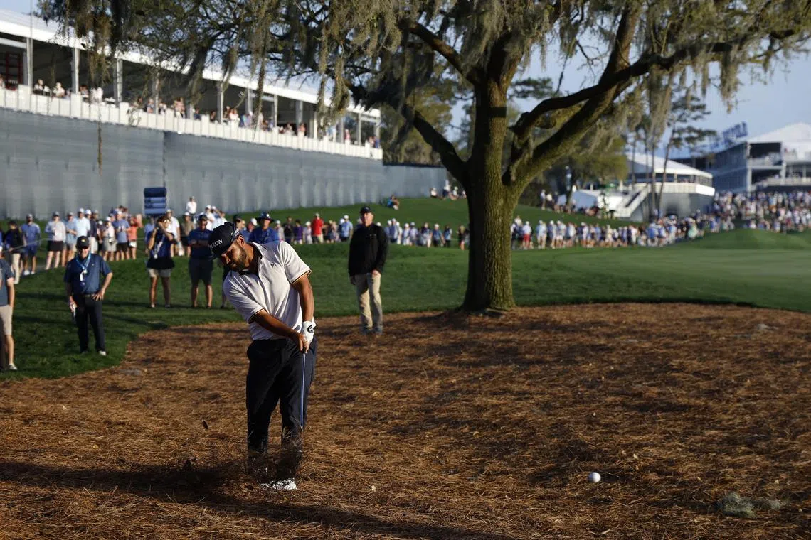 J.J. Spaun hits from the pinestraw on the the eighteenth fairway during the third round of The Players Championship.