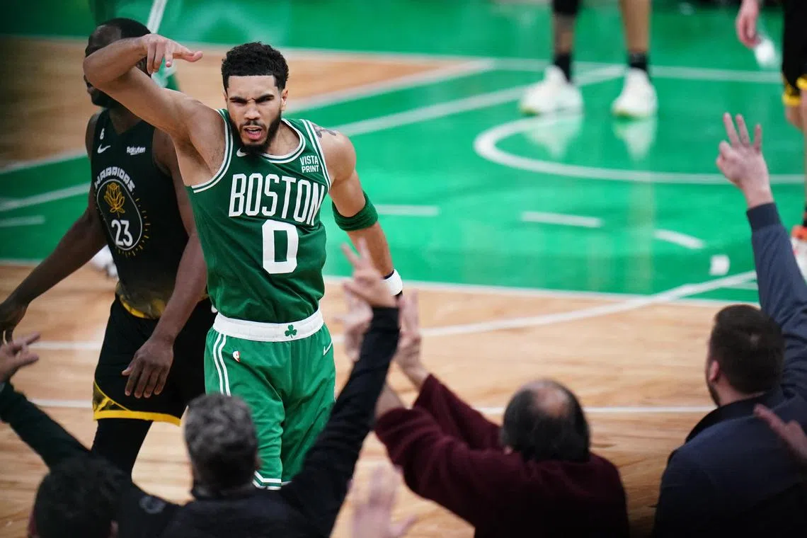 Jan 19, 2023; Boston, Massachusetts, USA; Boston Celtics forward Jayson Tatum (0) reacts after his three point basket against the Golden State Warriors in overtime at TD Garden.